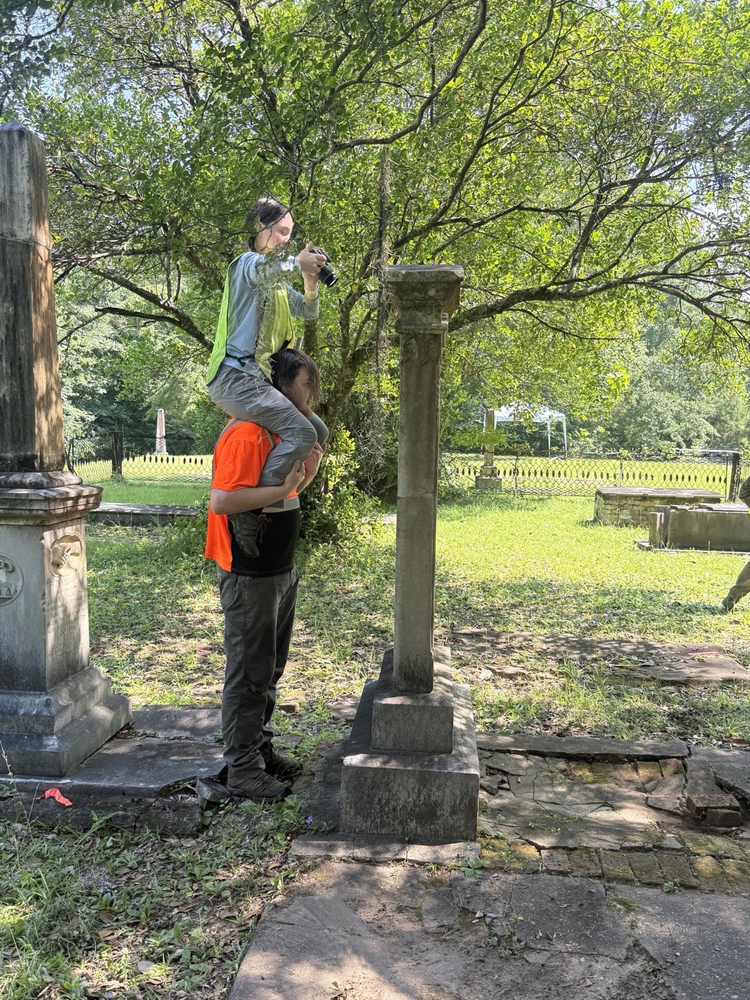 Participant photographing a cemetery monument for photogrammetric documentation