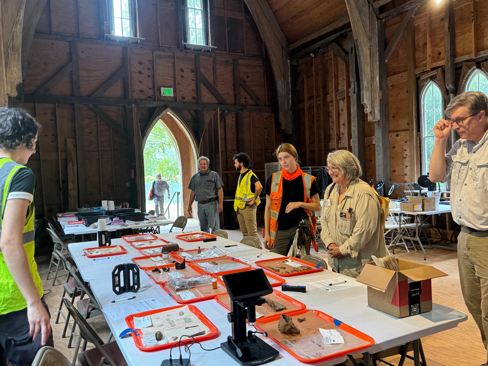 Visitors and participants examining archaeological material at Public Archaeology Day